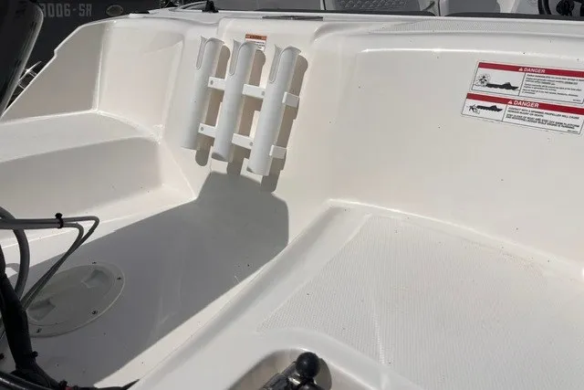Slide: The Image of 2024 Bayliner Element M15 boat interior with rod holders and safety warnings. - 3