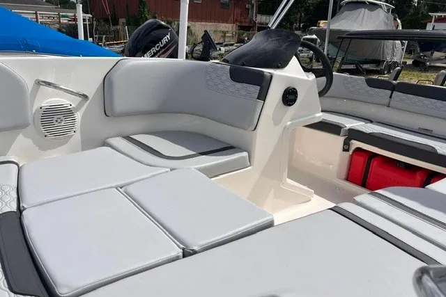 Slide: The Image of 2024 Bayliner Element M15 boat interior with cushioned seating and steering console. - 9