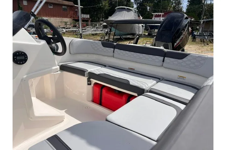Slide: The Image of 2024 Bayliner Element M15 boat interior with cushioned seating and storage compartments. - 8
