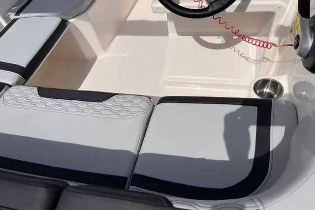 Slide: The Image of 2024 Bayliner Element M15 boat interior with cushioned seating and steering wheel. - 5