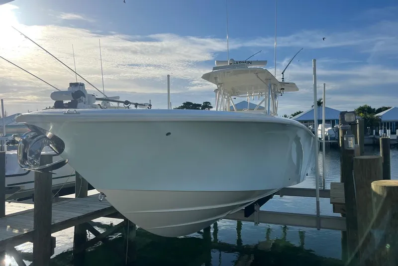 Slide: The Image of 2016 SeaVee 390Z boat docked at marina under a clear sky. - 2