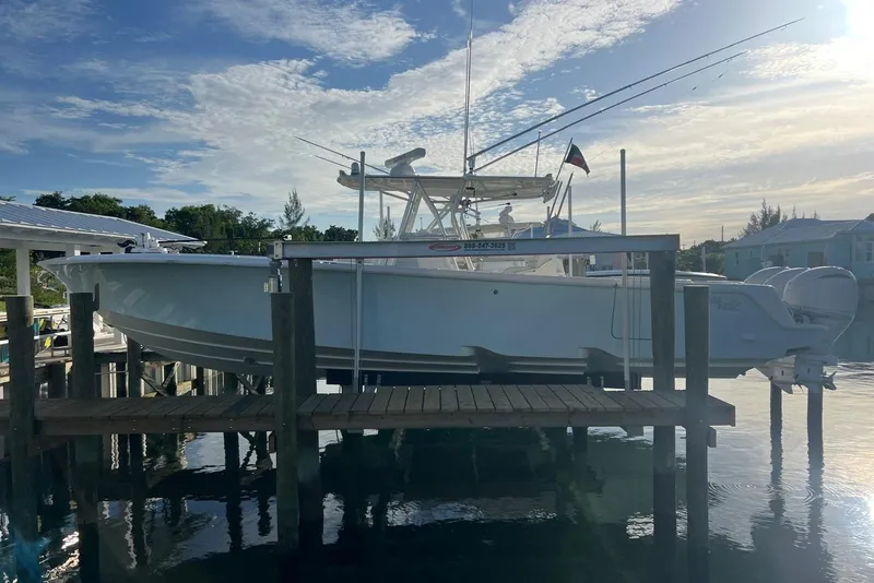 The Image of 2016 SeaVee 390Z boat docked, featuring sleek design and fishing equipment under a clear sky. - 1