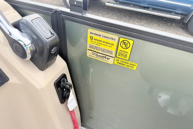 Slide: The Image of Control panel and capacity warning on 2027 Bentley Pontoons FISH 200 FISH-N-CRUISE boat. - 15