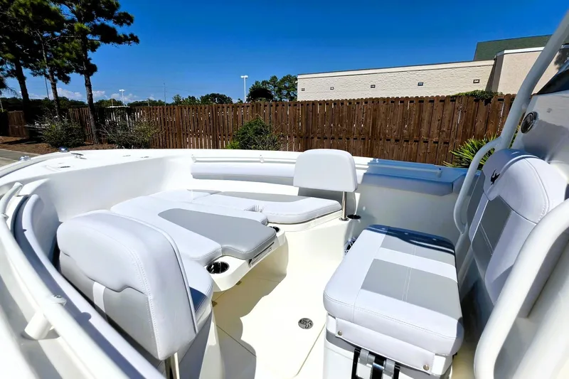 Slide: The Image of 2026 Mako 214 Center Console boat interior with white seating and modern design. - 18