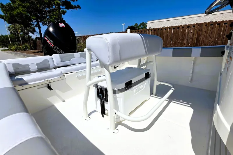 Slide: The Image of 2026 Mako 214 Center Console boat interior with seating and cooler. - 21