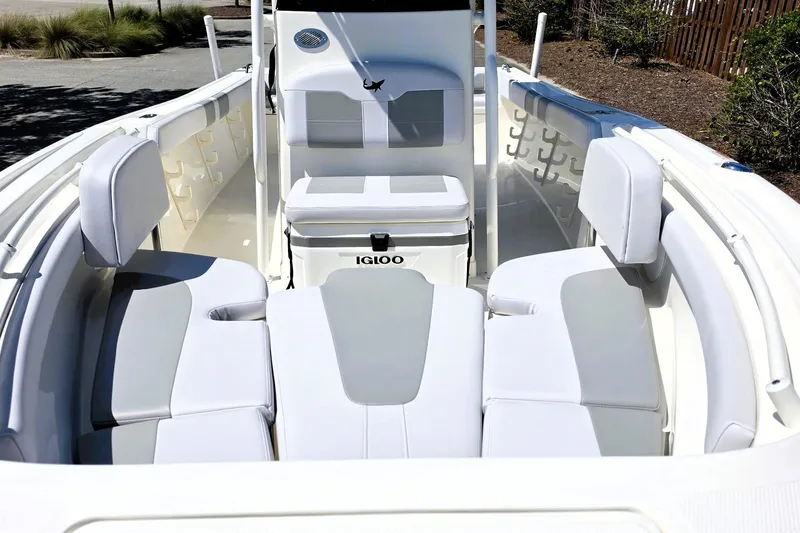Slide: The Image of 2026 Mako 214 Center Console boat interior with cushioned seating and Igloo cooler. - 17