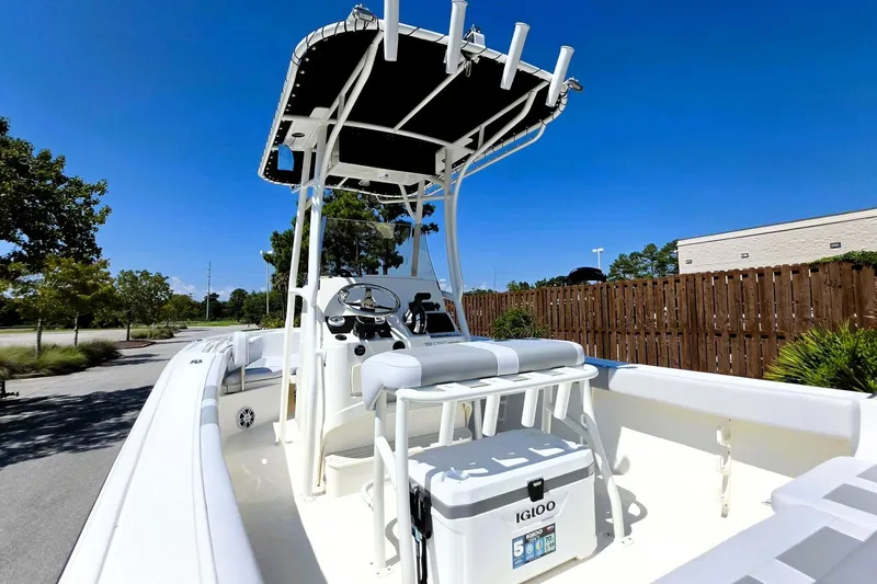 Slide: The Image of 2026 Mako 214 Center Console boat with T-top and Igloo cooler on deck. - 22