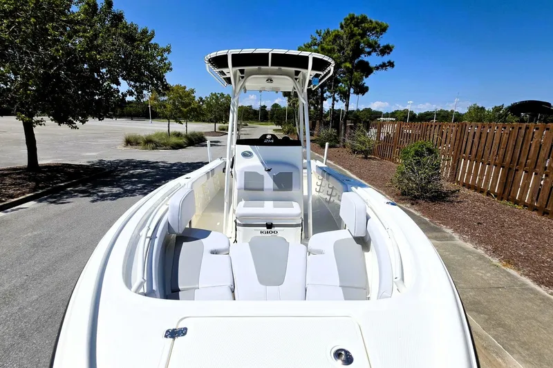 Slide: The Image of 2026 Mako 214 Center Console boat with seating, parked outdoors on a sunny day. - 16