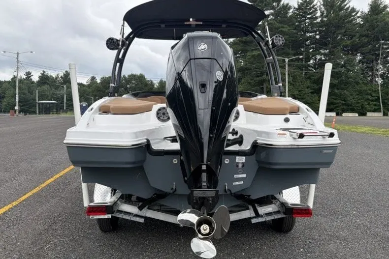 Slide: The Image of 2026 Tahoe 210 S boat rear view with outboard motor in parking lot. - 11