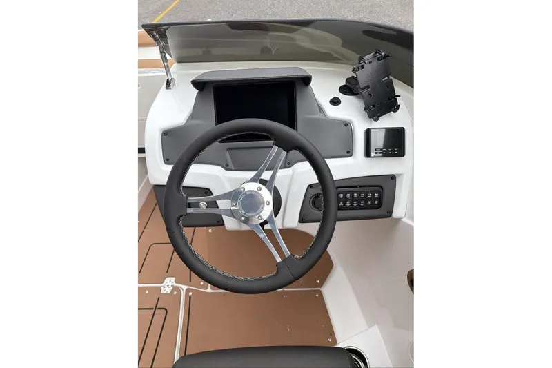 Slide: The Image of Steering console of 2026 Tahoe 210 S boat with modern controls and dashboard. - 10
