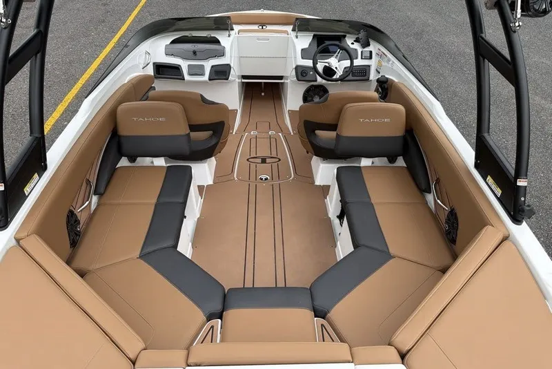 Slide: The Image of 2026 Tahoe 210 S boat interior with tan and black seating, modern dashboard, and spacious layout. - 9