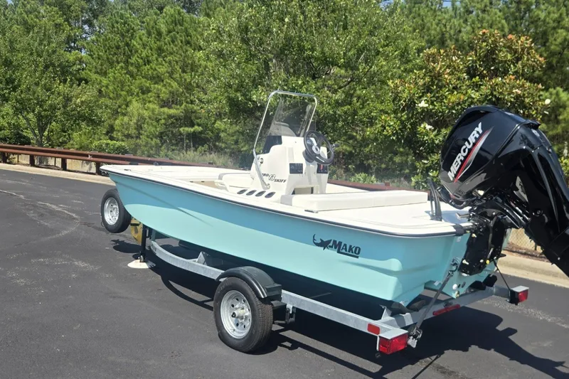 Slide: The Image of 2026 Mako Pro Skiff 13 CC boat on trailer, featuring Mercury outboard motor. - 2