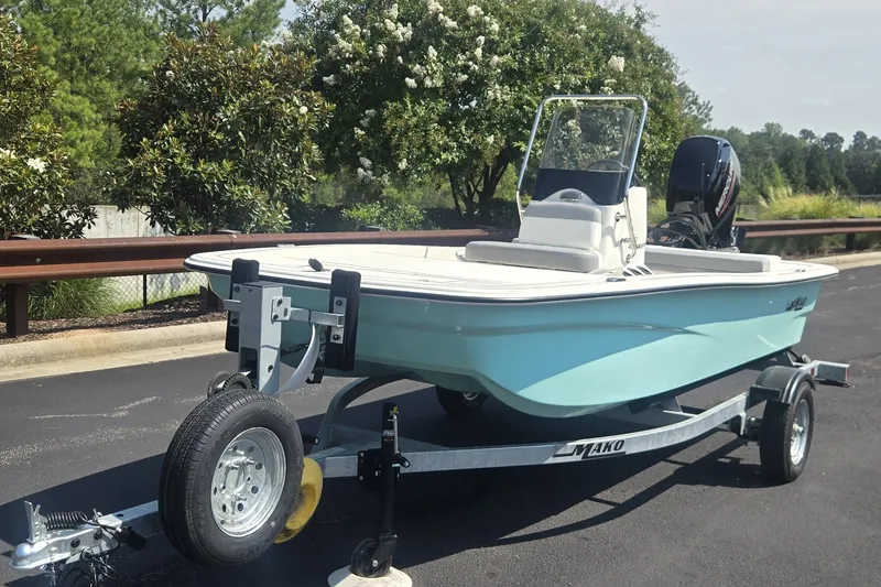 Slide: The Image of 2026 Mako Pro Skiff 13 CC boat on trailer, parked outdoors. - 1
