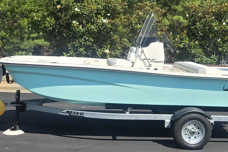 The Image of 2026 Mako Pro Skiff 13 CC boat on trailer, parked outdoors. - 0