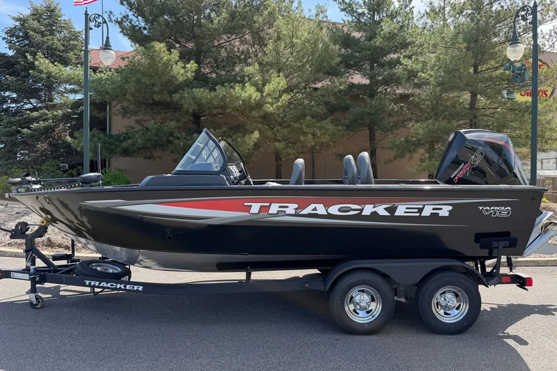 The Image of 2026 Tracker Targa V-19 WT boat on trailer, parked outdoors with trees in background. - 0