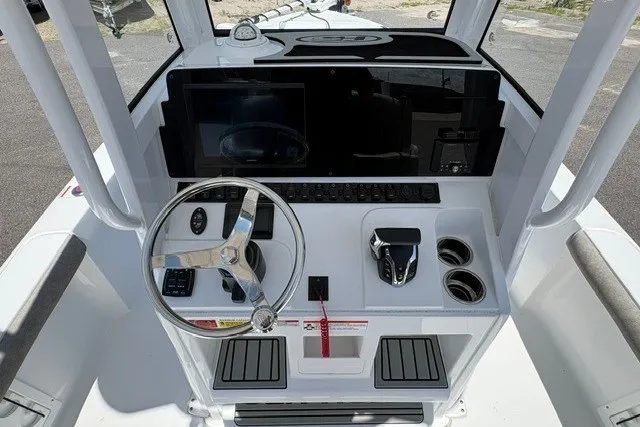 Slide: The Image of 2026 Sea Hunt BX25FS boat console with steering wheel and controls. - 8