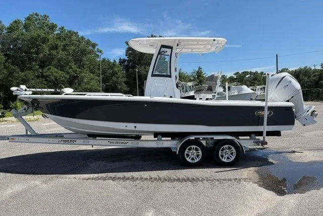 The Image of 2026 Sea Hunt BX25FS boat on trailer, parked outdoors, side view. - 1