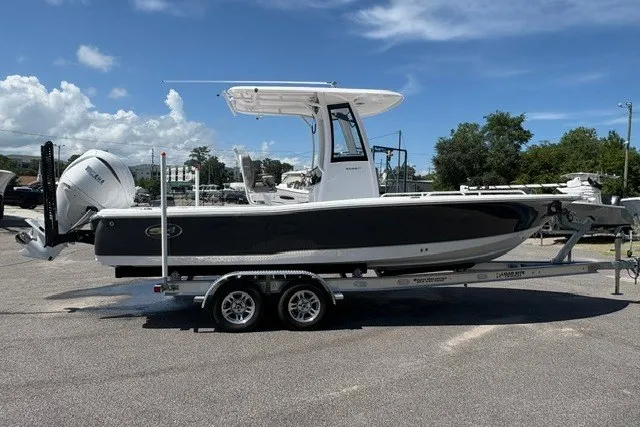 Slide: The Image of 2026 Sea Hunt BX25FS boat on trailer under clear blue sky. - 3