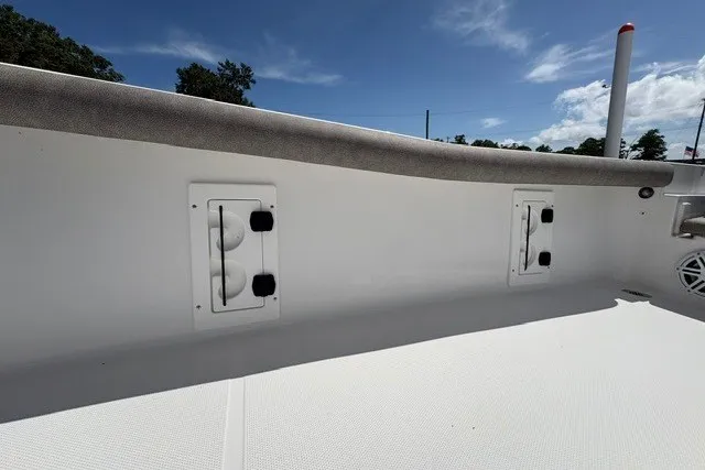 Slide: The Image of 2026 Sea Hunt BX25FS boat interior with storage compartments under a clear blue sky. - 10