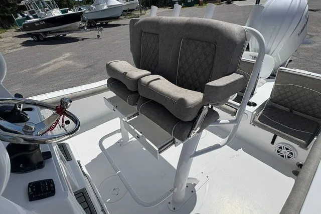 Slide: The Image of 2026 Sea Hunt BX25FS boat interior with dual cushioned seats and steering wheel. - 6
