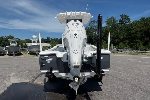Slide: The Image of 2026 Sea Hunt BX25FS boat with powerful 300 V6 engine, parked outdoors. - 2