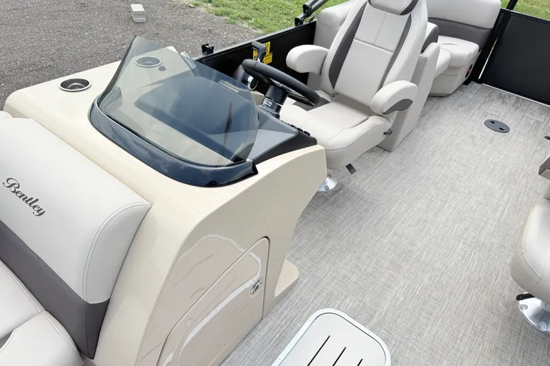 Slide: The Image of 2027 Bentley Pontoons Legacy 223 DL Navigator interior with beige seating and sleek dashboard. - 14