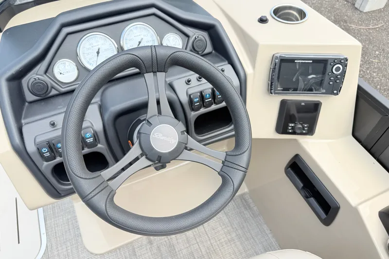 Slide: The Image of Steering console of 2027 Bentley Pontoons Legacy 223 DL Navigator with gauges and controls. - 18