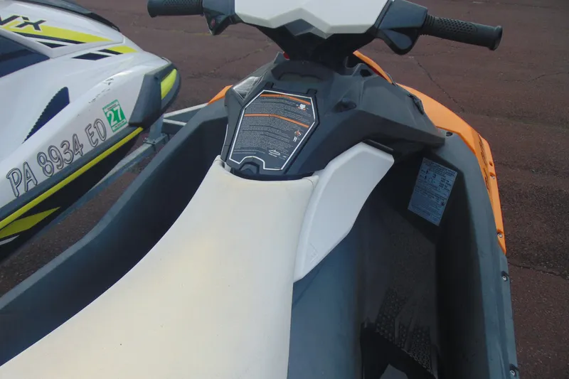 Slide: The Image of 2015 Sea-Doo Spark 2up jet ski, orange and white, parked on pavement. - 7