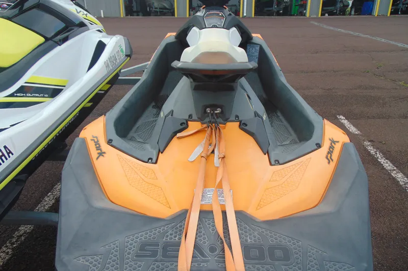 Slide: The Image of 2015 Sea-Doo Spark 2up jet ski in orange, parked on asphalt. - 5