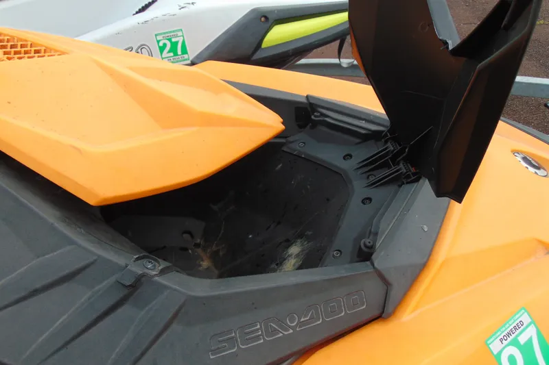 Slide: The Image of 2015 Sea-Doo Spark 2up with open storage compartment, showcasing orange exterior. - 10