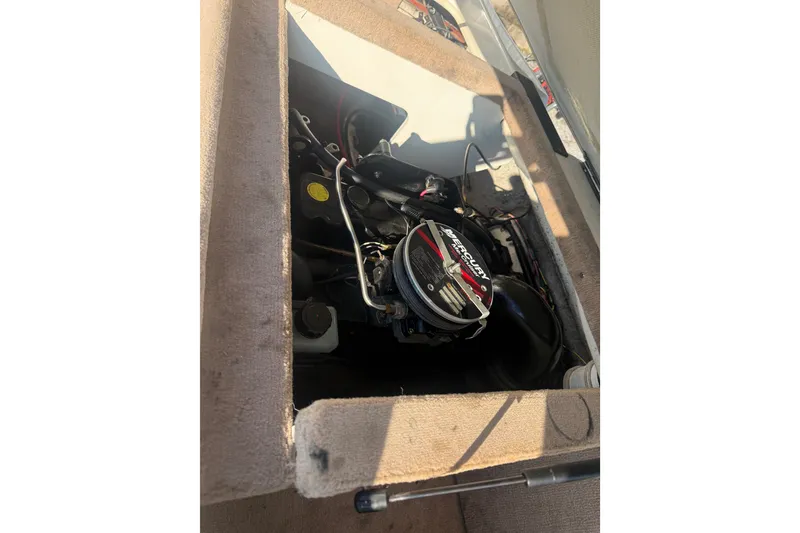 Slide: The Image of Engine compartment of a 2000 Searay 180 boat, featuring a Mercury engine. - 13