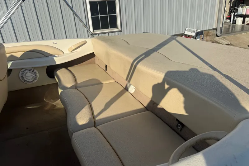 Slide: The Image of Interior of a 2000 Searay 180 boat with beige seating and speaker. - 10