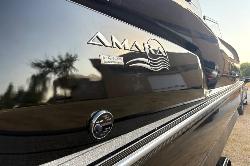 Slide: The Image of 2019 SunCatcher Amara boat with sleek black exterior and reflective finish. - 22