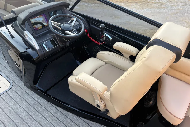Slide: The Image of Captain's seat and dashboard of 2019 SunCatcher Amara boat with steering wheel and controls. - 14