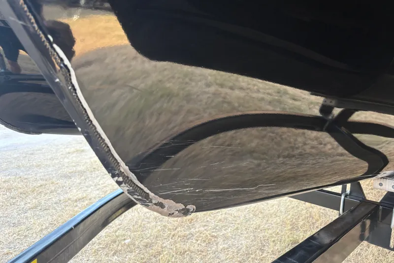 Slide: The Image of Close-up of a 2019 SunCatcher Amara boat hull with visible scratches and wear. - 25