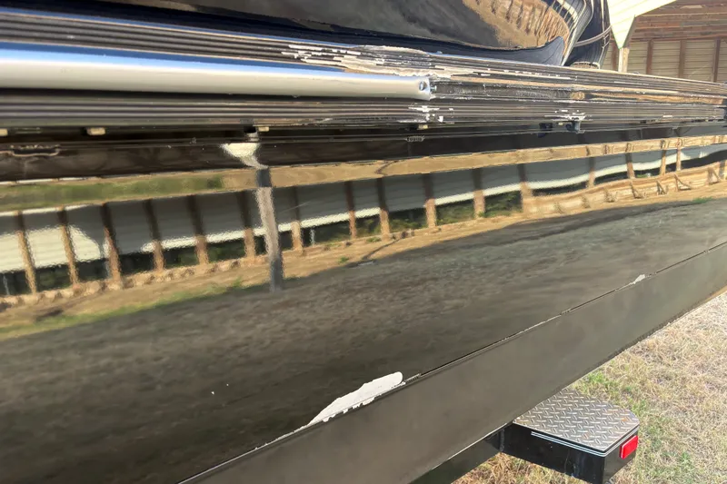 Slide: The Image of Close-up of 2019 SunCatcher Amara boat hull with visible scratches and reflections. - 23