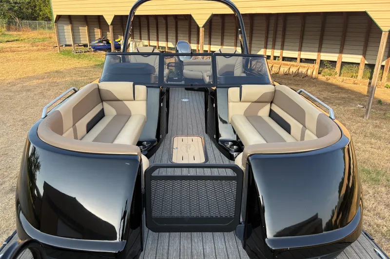 Slide: The Image of 2019 SunCatcher Amara pontoon boat with beige seating and sleek black exterior. - 9