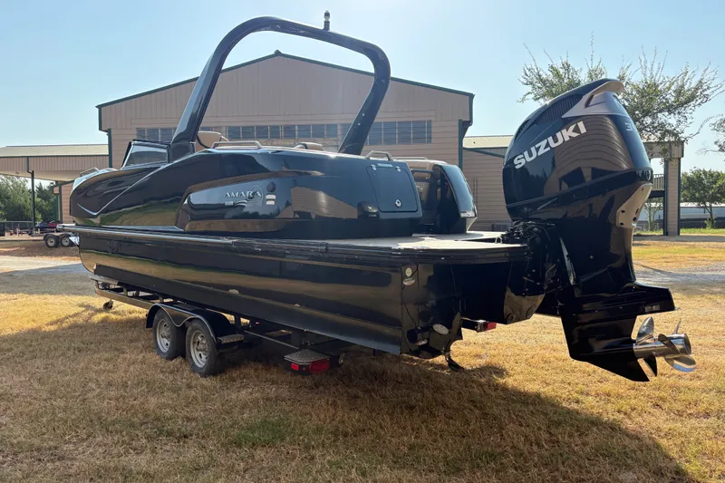 Slide: The Image of 2019 SunCatcher Amara boat with Suzuki engine on trailer, parked outdoors. - 31