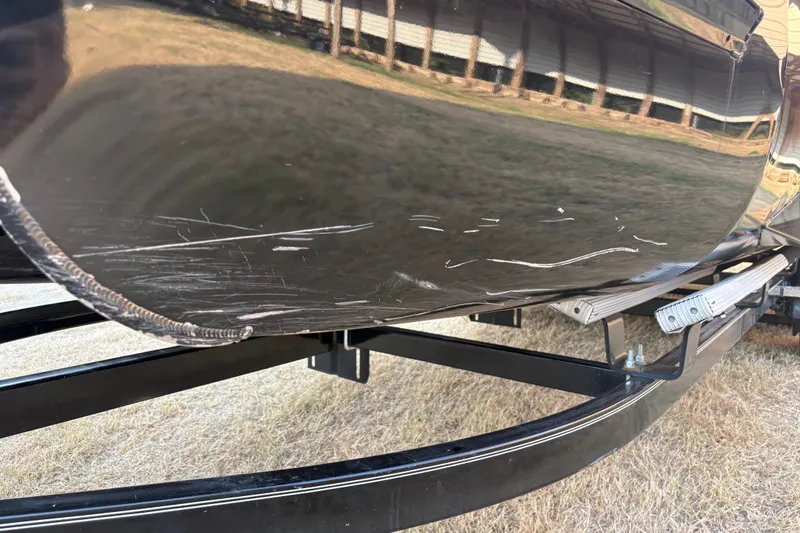 Slide: The Image of Scratched hull of a 2019 SunCatcher Amara boat on a trailer. - 24