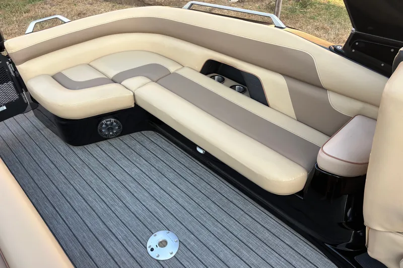 Slide: The Image of Luxurious seating area on a 2019 SunCatcher Amara boat with beige upholstery and cup holders. - 16