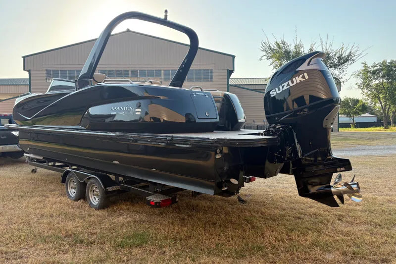 Slide: The Image of 2019 SunCatcher Amara boat with Suzuki engine on trailer, parked outdoors. - 7