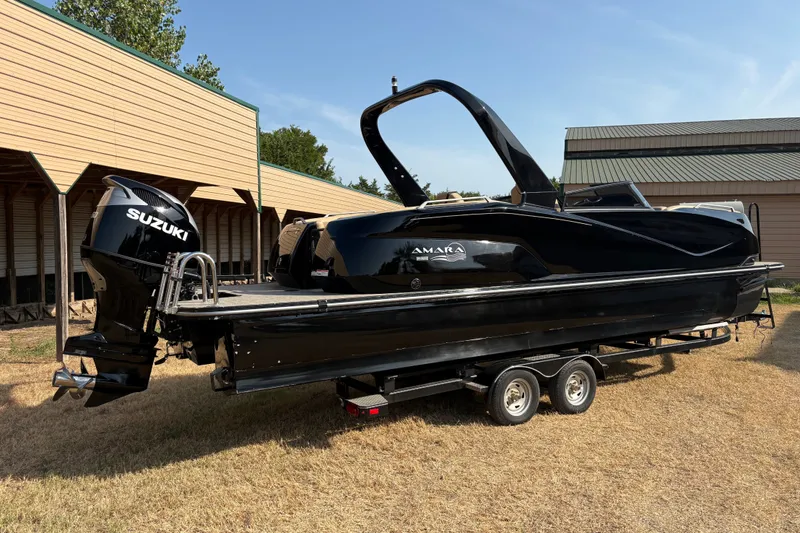 Slide: The Image of 2019 SunCatcher Amara boat with Suzuki engine on trailer, parked outdoors. - 28