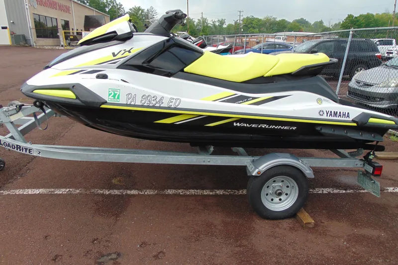 The Image of 2021 Yamaha WaveRunner VX on trailer, featuring sleek design and vibrant yellow accents. - 2
