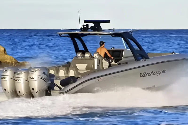 Slide: The Image of 2021 Midnight Express 37 Open boat speeding on ocean with triple Mercury 400 engines. - 2