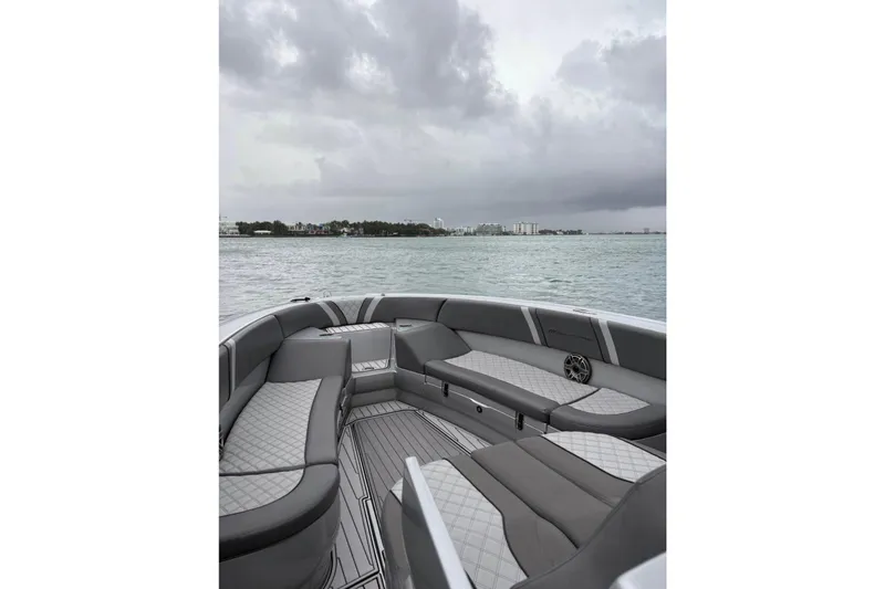 Slide: The Image of Luxurious 2021 Midnight Express 37 Open boat interior with gray seating on a cloudy day. - 10