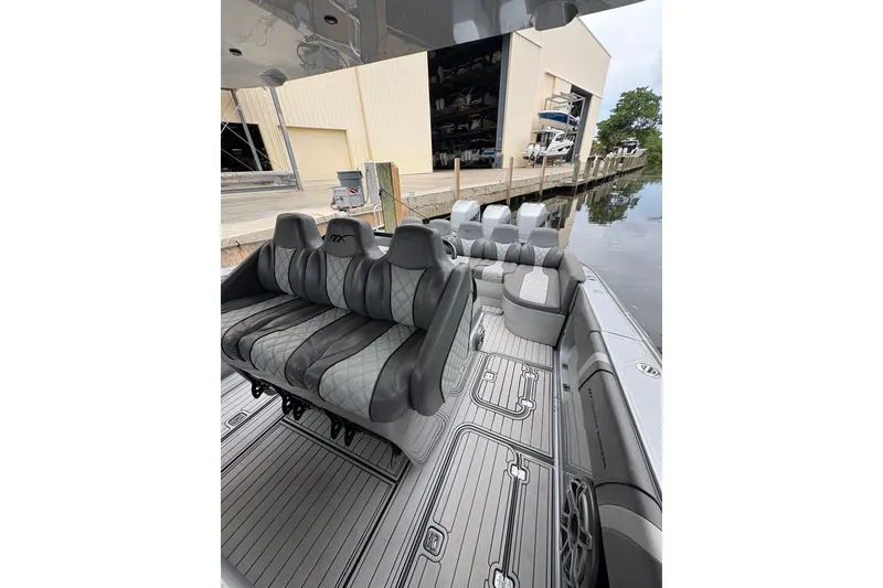 Slide: The Image of 2021 Midnight Express 37 Open boat with luxurious seating and sleek design docked by the water. - 6