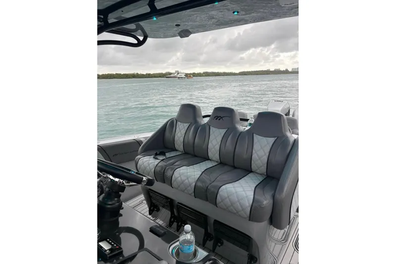 Slide: The Image of Luxury seating on a 2021 Midnight Express 37 Open boat with scenic water view. - 12