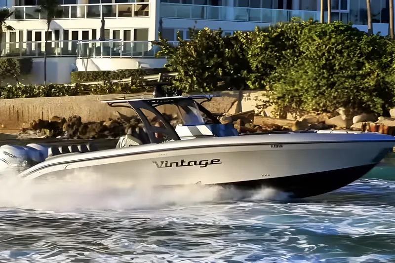 Slide: The Image of 2021 Midnight Express 37 Open boat cruising near a coastal residence. - 4