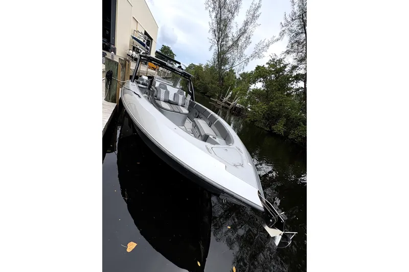 Slide: The Image of 2021 Midnight Express 37 Open boat docked in a serene, wooded waterway. - 5