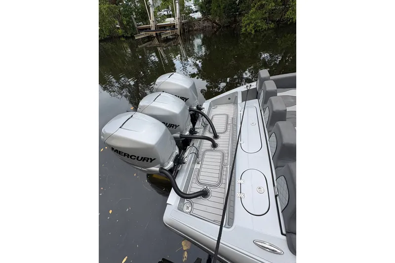 Slide: The Image of 2021 Midnight Express 37 Open boat with triple Mercury outboard engines docked by the water. - 8